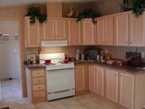 white kitchen stove with maple cabinets