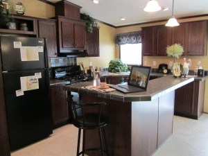 Furnished kitchen with walnut cabinetry