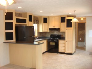 light kitchen cabinets with black appliances
